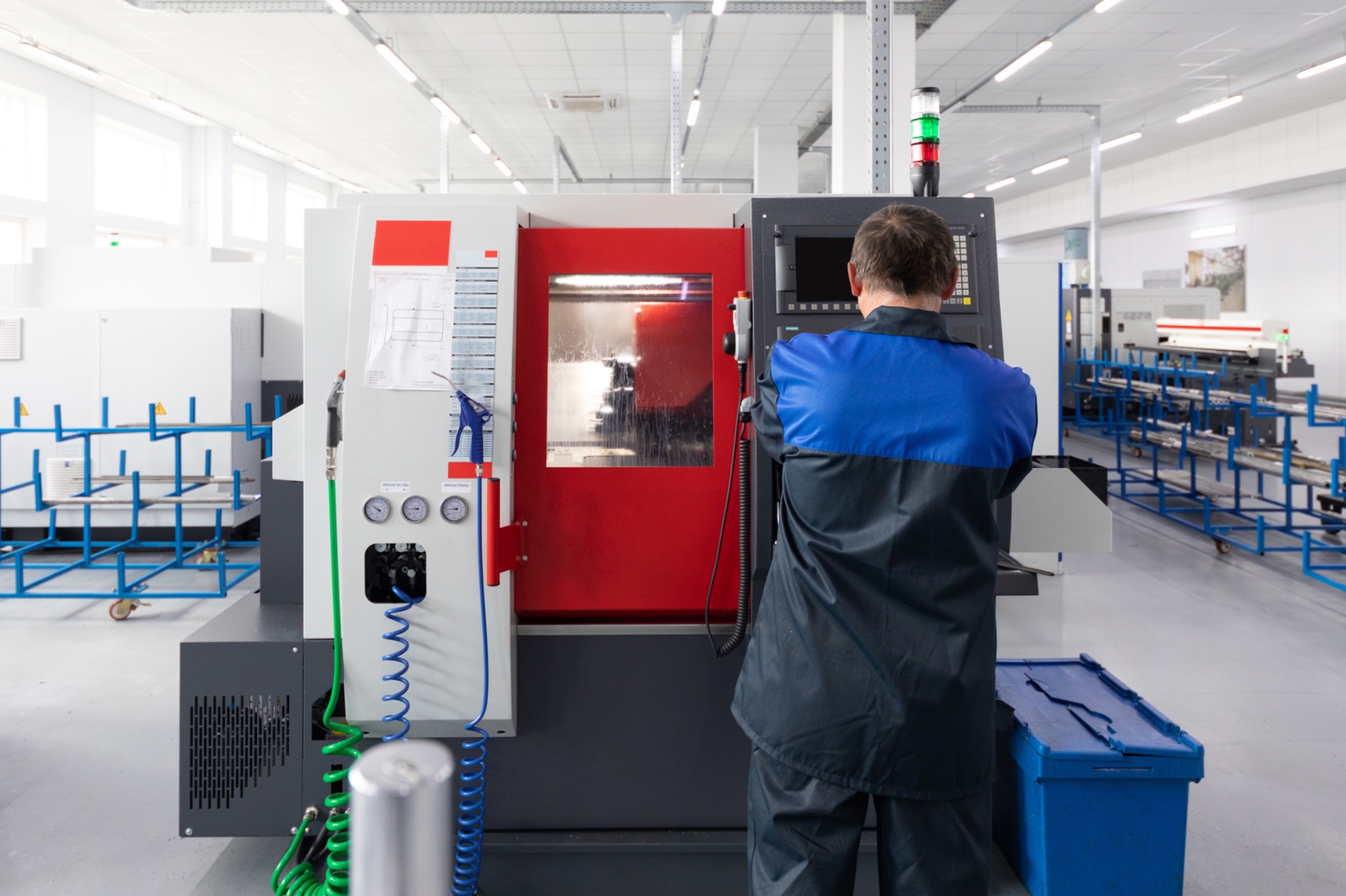 Engineer operating CNC machine in factory