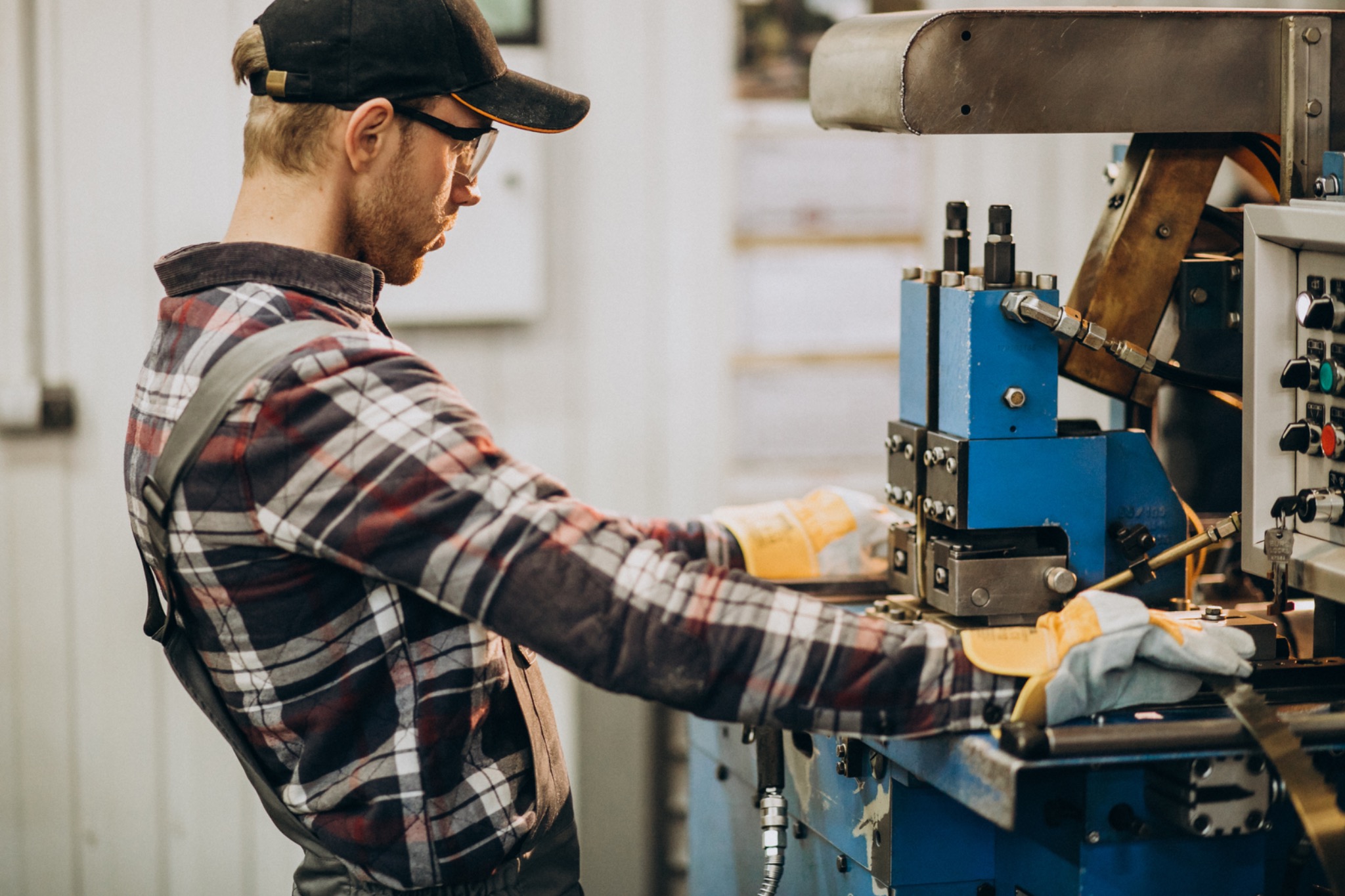 Factory worker operating industrial machine